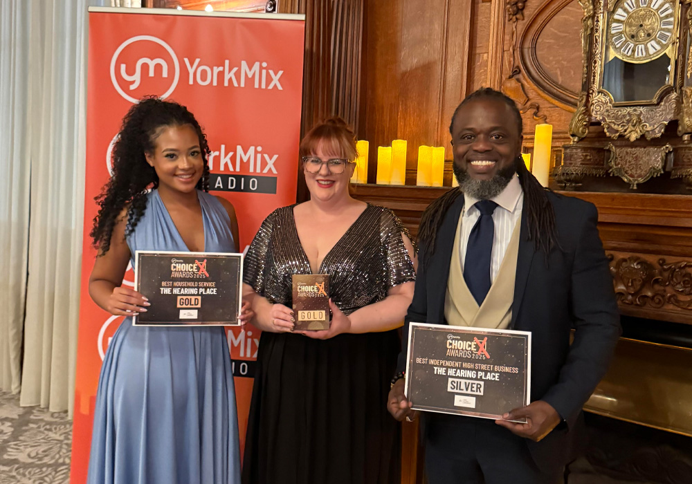 The Hearing Place Team collecting the Gold Award from the York Mix Awards for Best Household Service and the silver award for Best Independent High Street Business